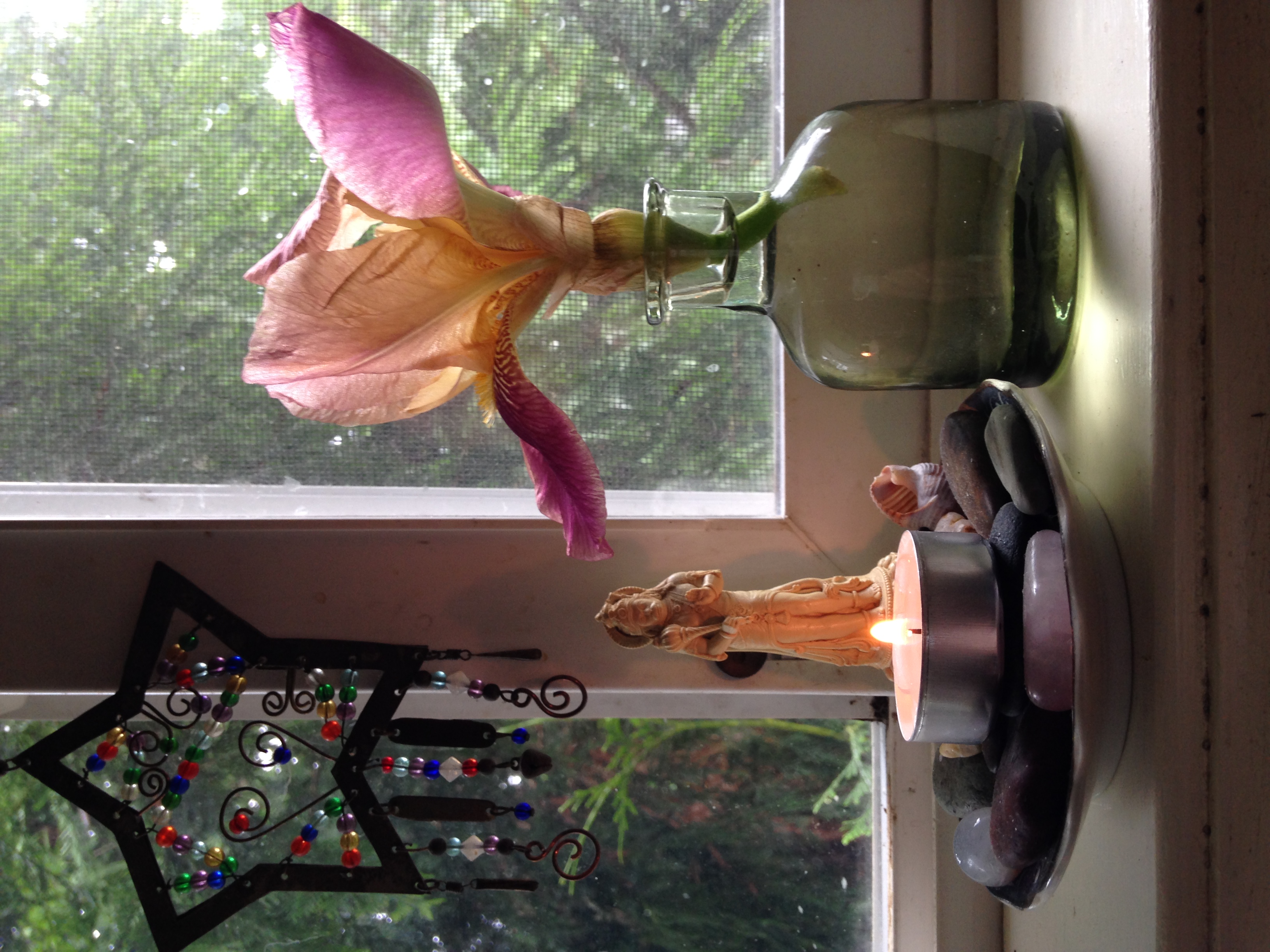 A small iris and altar in a windowsill.